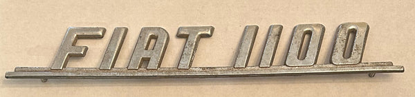 FIAT 1100 RARE VINTAGE NOS SCRIPT BADGE. TWO PIN TYPE